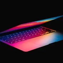 Kolorowy laptop, idealny do pracy w Photoshopie, z podświetlaną klawiaturą w odcieniach tęczy.